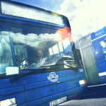 Close-up of the front of a blue colored bus. Photo.